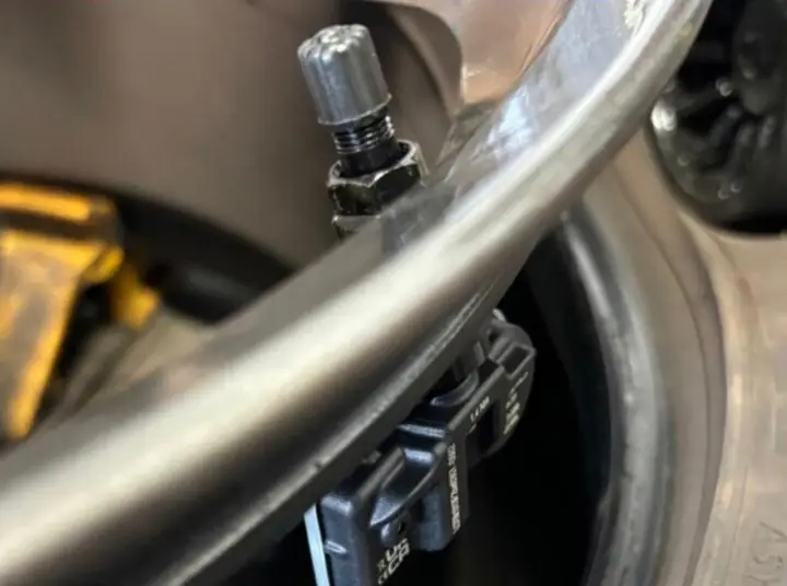 That tyre-pressure warning light is an MOT failure. We test, replace and programme TPMS valves and sensors on site.